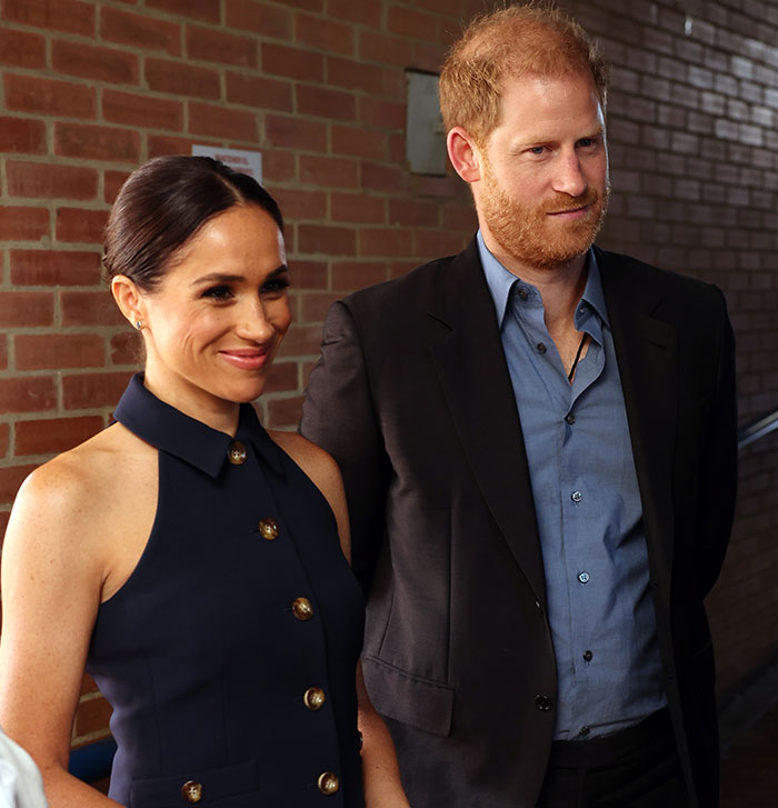 Man and woman smiling together, linked to Meghan Markle and Prince Harry Vanity Fair article.