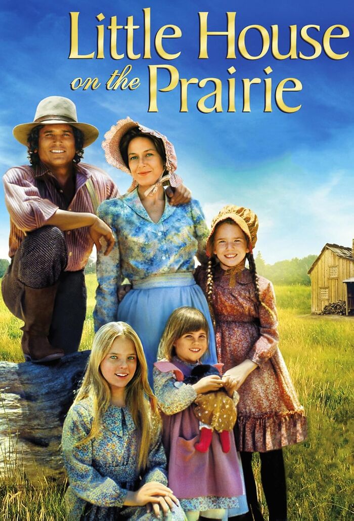 "TV show characters from Little House on the Prairie in a field with a house background."