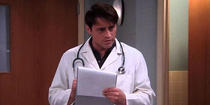 Person in a doctor's coat, possibly from a TV show, illustrating fan disappointment moments in television.