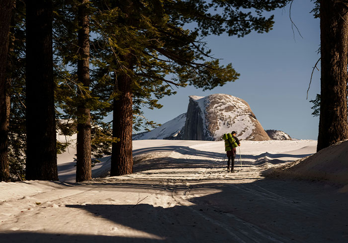 A hiker explores snowy American landscape, showcasing experiences normal to US citizens.