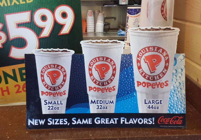 Popeyes drink sizes: Small 22oz, Medium 32oz, Large 44oz, offer unique to US fast-food chains.