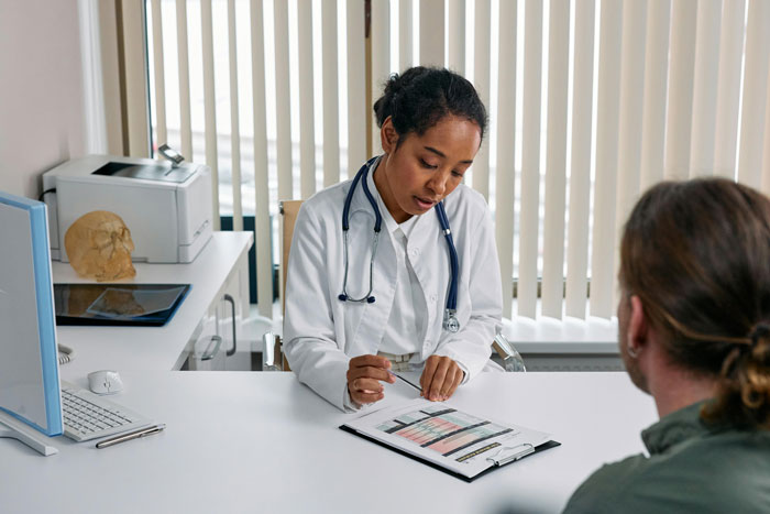 A nurse discussing a hysterectomy during an appointment with a patient.