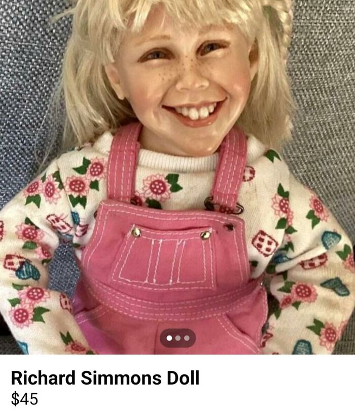 Smiling doll with blonde hair and pink overalls, considered creepy, available for purchase online.