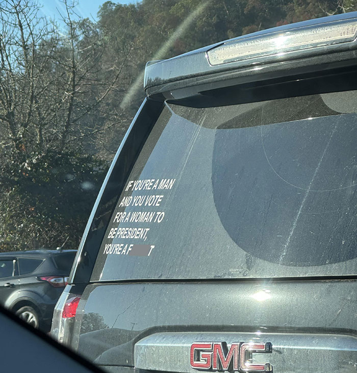 SUV with offensive political sticker, illustrating people being complete jerks.