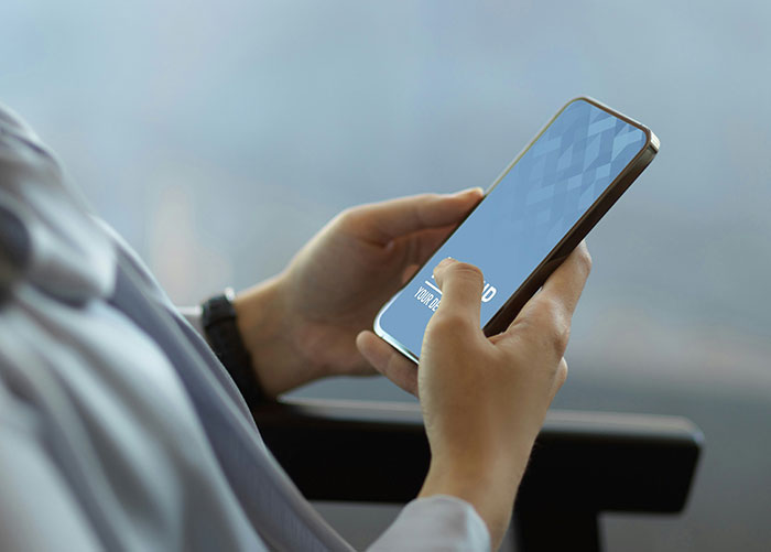 Person holding a smartphone, possibly engaged in nostalgic browsing related to peaking in high school.