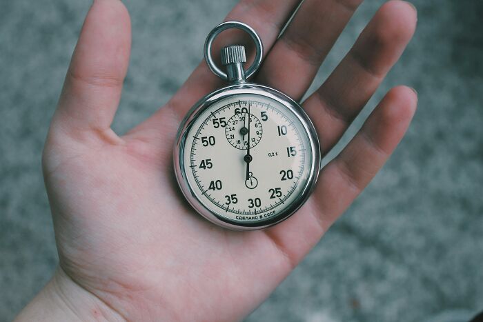 Person holding a stopwatch, illustrating the concept of understanding challenges.