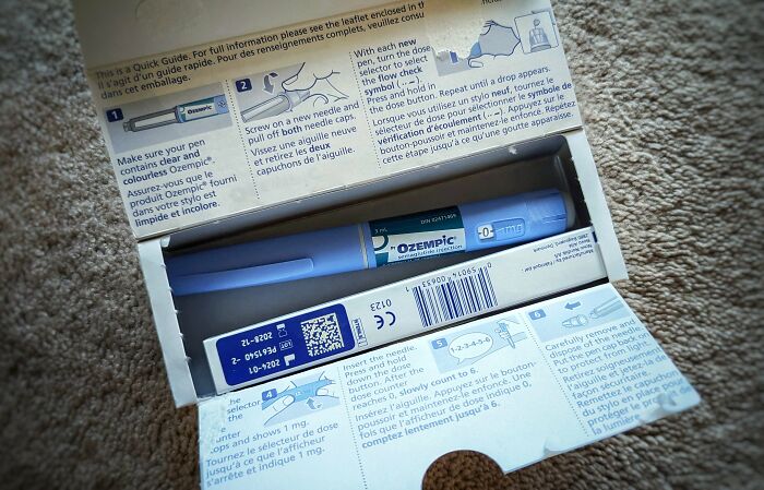 Weight-loss tip: Ozempic pen in its packaging on a carpeted surface, highlighting medication option.