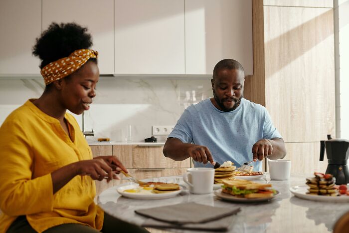 Couple enjoying a healthy breakfast at home, illustrating weight-loss tips with food swaps.