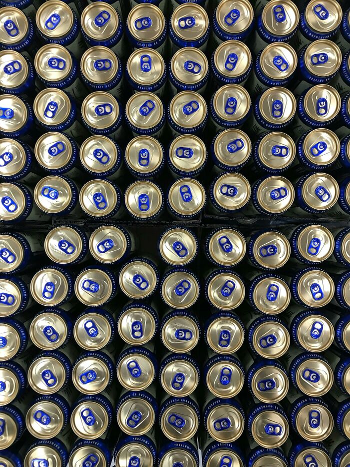 A large stack of aluminum cans viewed from above, possibly representing a lifetime supply.