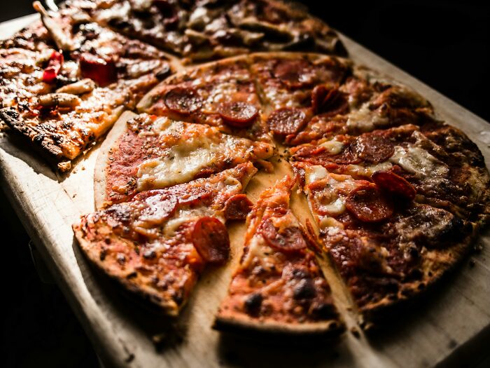 Pizza with pepperoni and cheese, illustrating the joy of a lifetime supply experience shared by many.