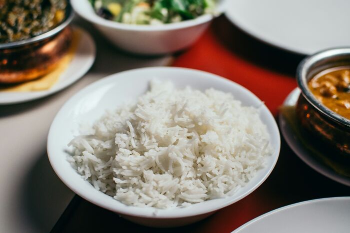 A bowl of fluffy white rice on a table, part of a meal shared by people who won a lifetime supply.