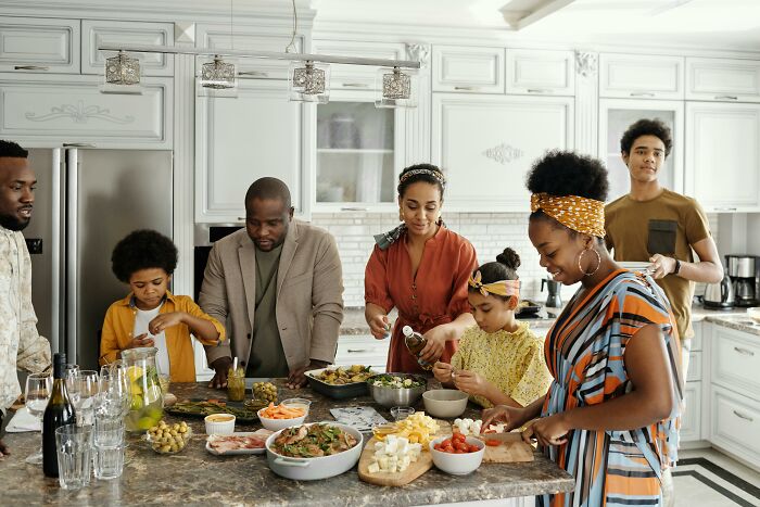 Family cooking together in a kitchen.