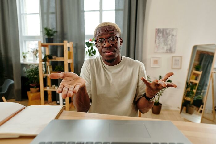 Man with glasses sitting indoors, expressing a puzzled look, related to creepy and unexplainable events.