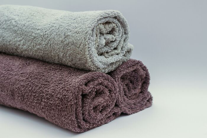 Luxurious rolled towels emphasizing expensive items worth spending money.