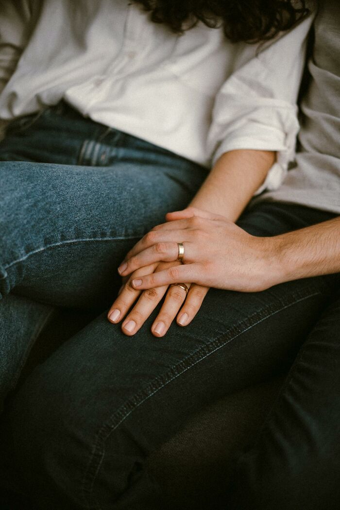 Couple holding hands, showcasing intimate connection, highlighting non-sexual attraction in relationships.