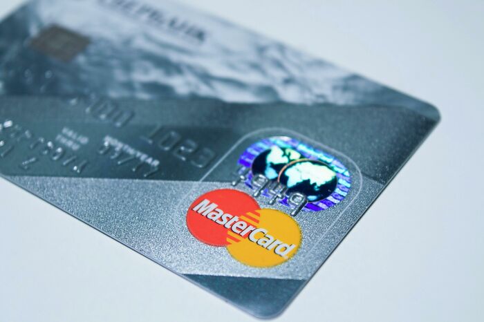 Close-up of a MasterCard credit card, showing the card's chip and logo.