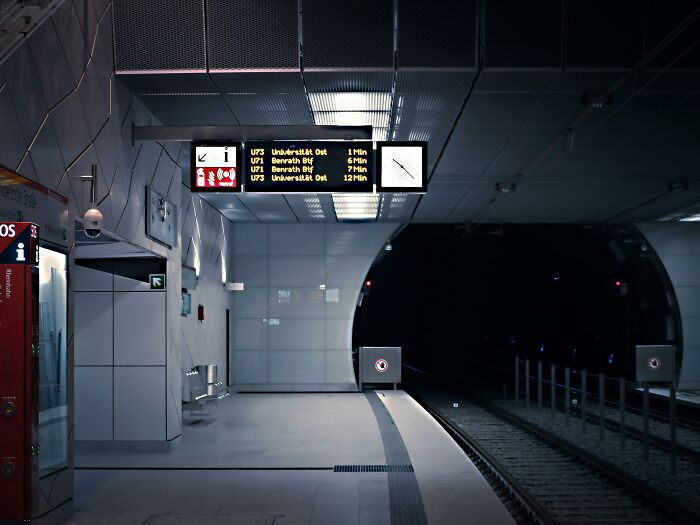 Empty metro platform with dim lighting, creating a creepy and unsettling atmosphere.