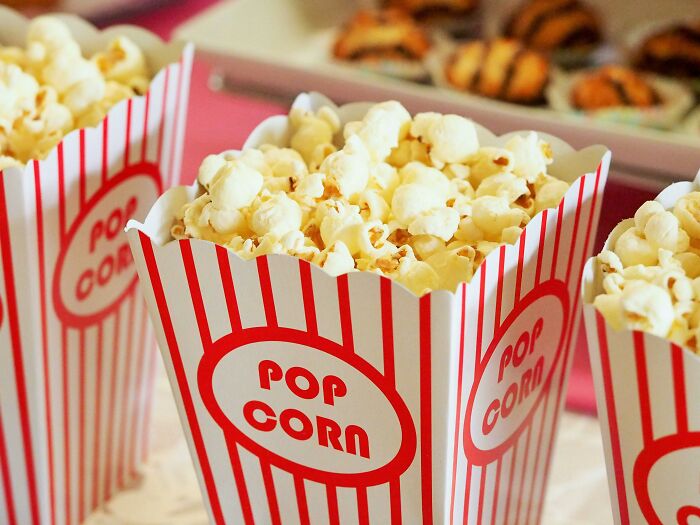 Popcorn in striped boxes at a theater, perfect for enjoying iconic movie titles with missing numbers.