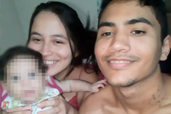 A couple smiling with their baby, related to news about a pregnant woman on life support.