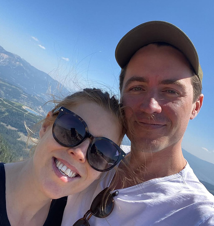 Princess Beatrice and Edoardo Mapelli Mozzi taking a selfie outdoors, with mountains and blue sky in the background.