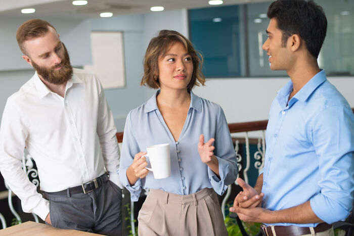 Three people engage in a discussion, showcasing effective psychological tricks in communication.