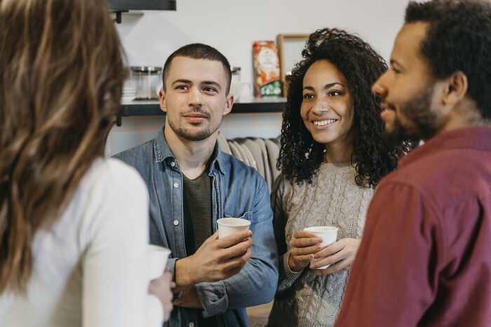 A group of people engaging in conversation, illustrating psychological tricks in social interactions.