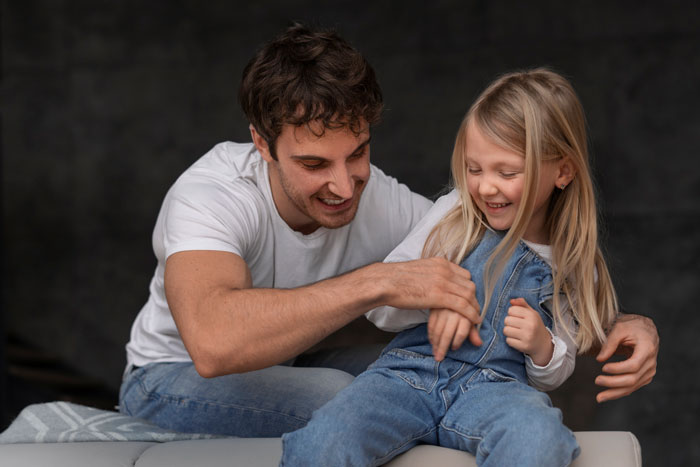 Man in casual wear playing with stepchild, highlighting hobbies and family dynamics.