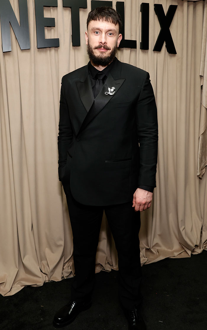 Richard Gadd in black tuxedo at Netflix backdrop, Golden Globes 2025 after-party, worst dressed highlight.