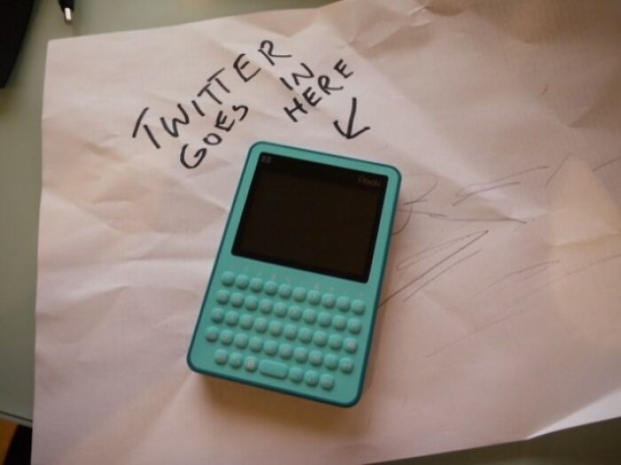 Turquoise gadget resembling a mini keyboard on paper labeled "Twitter goes in here," showcasing historical invention.