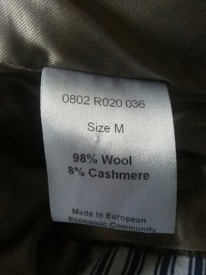 Clothing label showing size M, made of 98% wool and 8% cashmere, with a science meme twist.