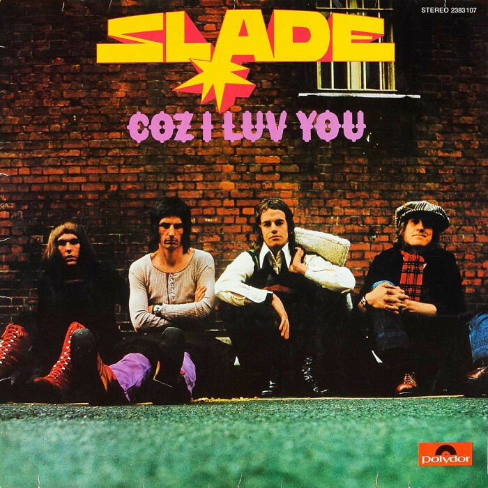 1970s album cover with band sitting against a brick wall, featuring 'Slade - Coz I Luv You' in bold yellow and purple text.