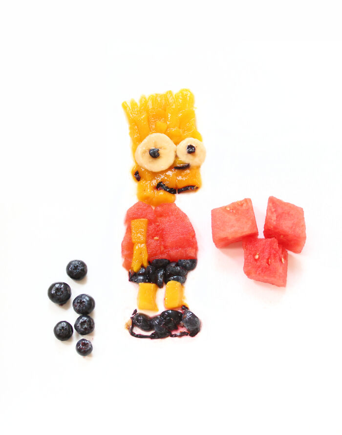 Cartoon-inspired food art design using fresh ingredients, with blueberries and watermelon cubes.