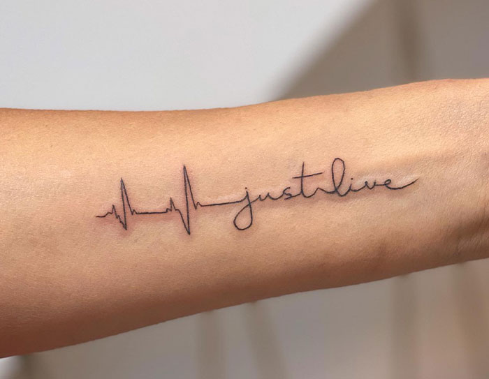 Tattoo of an EKG line blending into the words "just live" on a forearm, related to unsolicited opinion discussion.