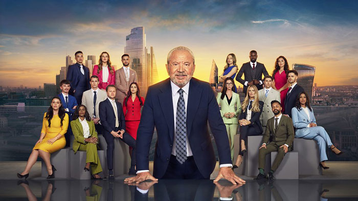 Group of professionals in formal attire with city skyline backdrop, featuring freelance magician theme.