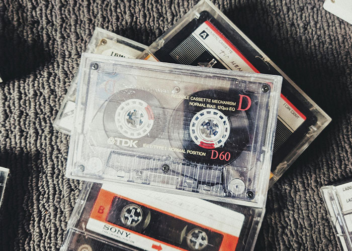 Cassette tapes on a textured surface, representing older people's nostalgia and the lessons shared with grandparents.