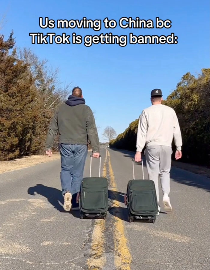 Two men walking down a road with luggage, reacting to TikTok ban, exploring life unplugged from the Matrix.