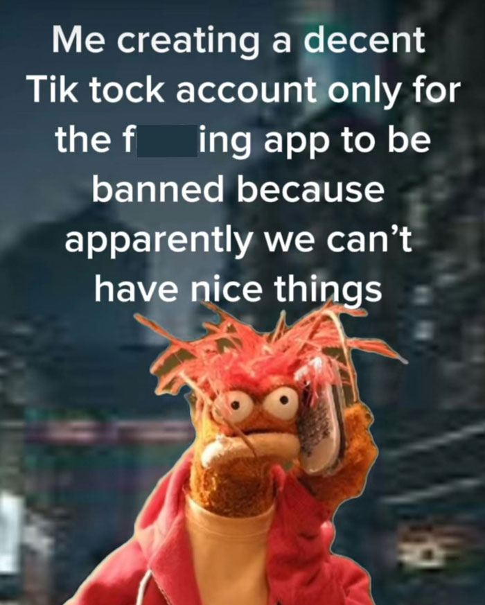 A puppet reacting to TikTok ban news, holding a phone with a shocked expression.