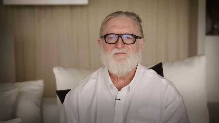 Elderly man with glasses and a white beard, sitting on a sofa, related to new facts from the "Today I Learned" community.