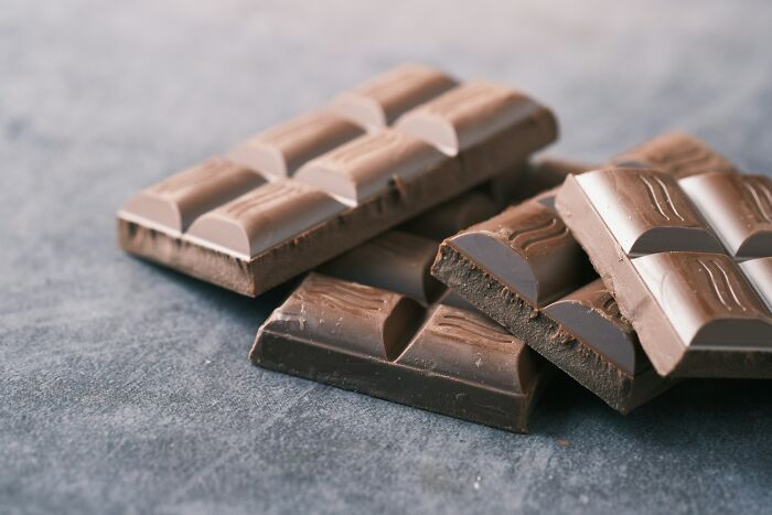 Luxurious chocolate bars on a gray surface, showcasing expensive items worth spending money on.