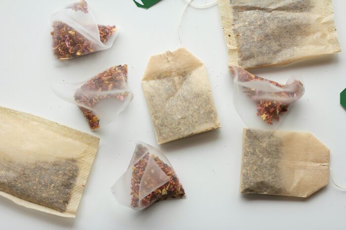 Tea bags scattered across a white surface, potentially highlighting toxic elements for the body.