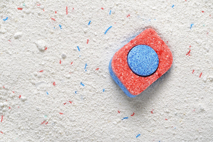 Dishwasher tablet on a powdery surface, illustrating one of the toxic things in household cleaning products.