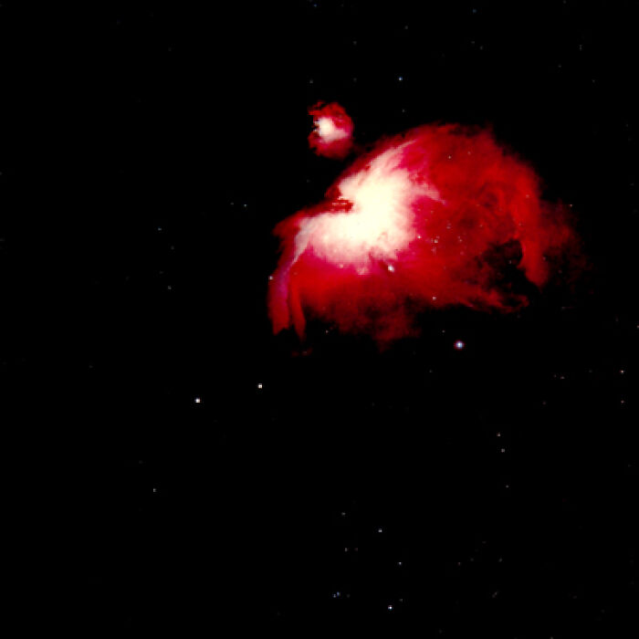 A vibrant red and white nebula glows in the dark universe, symbolizing the timeless impact of '70s songs.