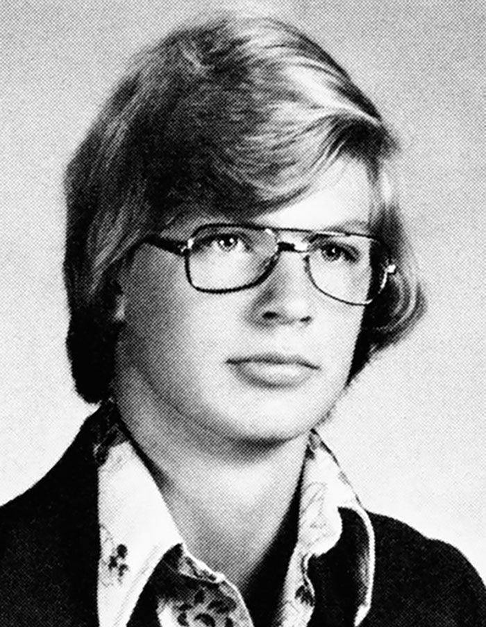 Black and white portrait of a young person with glasses, related to true crime plot twists.