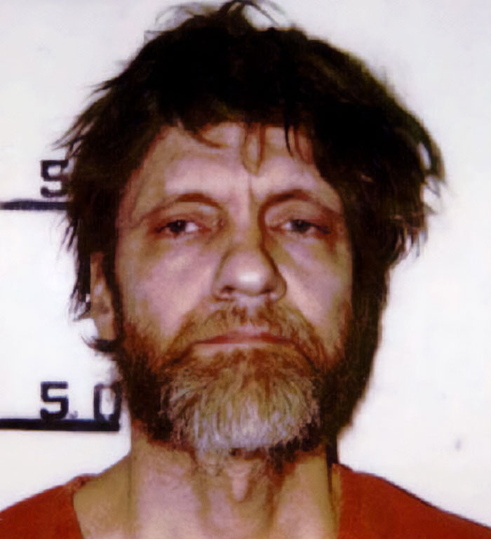 A person in a mugshot, relevant to true crime cases plot twists, with a measuring scale in the background.