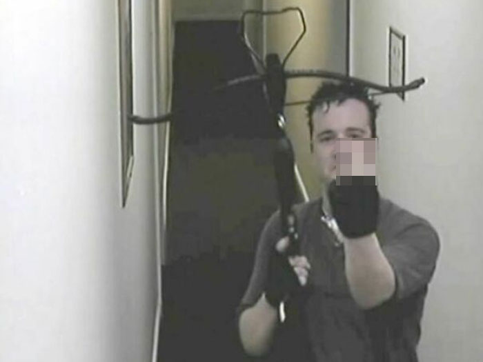 Person holding a crossbow in a narrow hallway, related to true crime stories and curiosities.