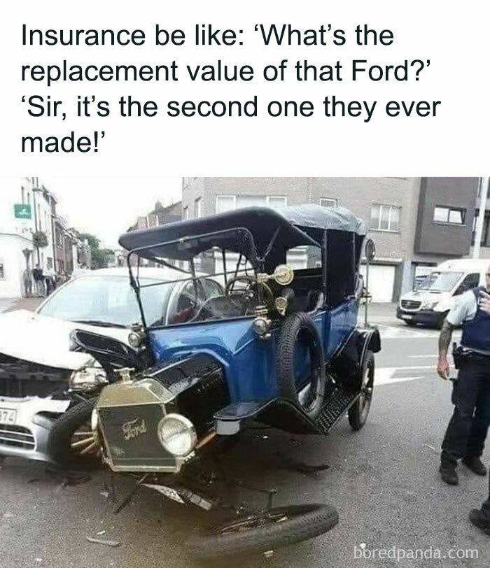 Broken vintage Ford vehicle after a costly-looking accident with a white car, being inspected by police officers.