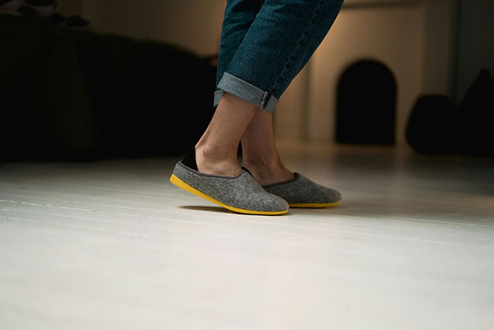 Person in hotel wearing casual slippers, following unspoken rules about footwear.