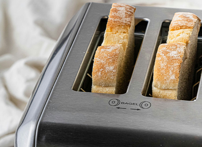 Bread slices in a toaster's bagel setting, demonstrating using things the wrong way.