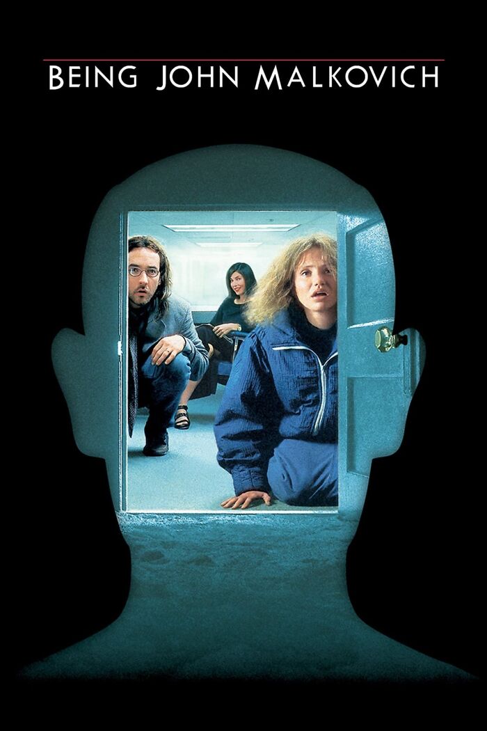 Scene from Best Nostalgia Movies, three people crouched in a room seen through a silhouette of a head.