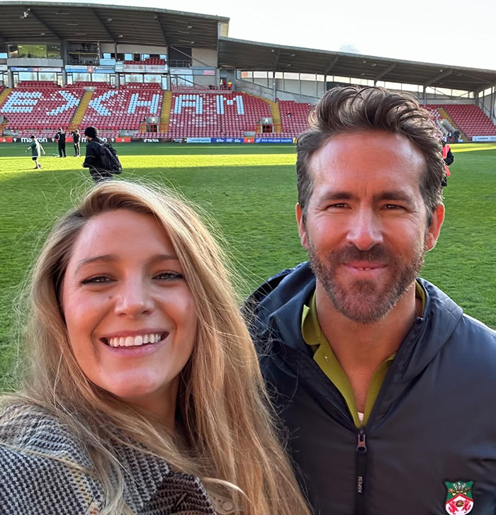 I don't know who these people are, but for the image you provided: A smiling duo taking a selfie on a sports field.